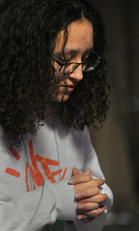 St. Joseph University School student Lily Johnson prays in a make-shift chapel during 